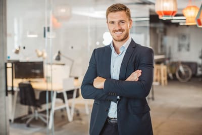 Dirigeant en veste, dans un espace de travail ouvert
